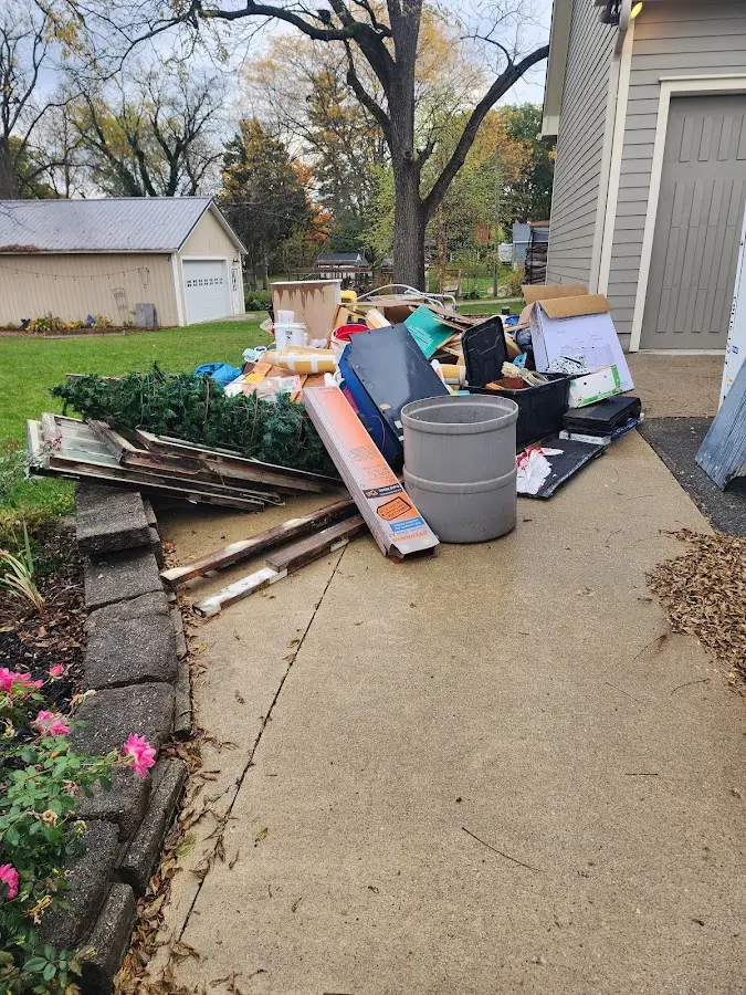 Dumpster being loaded with debris for 12 Yard Dumpster Rental in Brainerd